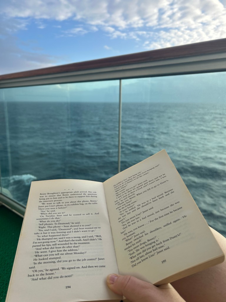 Reading a book on balcony on first sea day